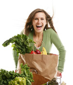 a girl smiling while holding groceries