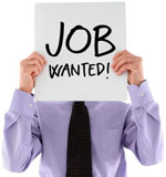 a person holding a job wanted sign